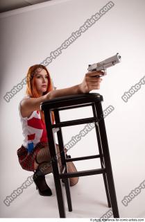 TINA KNEELING POSE WITH GUNS
